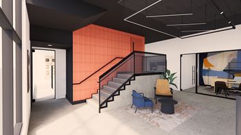 A rendering of a stairwell in an office space with two chairs and a table